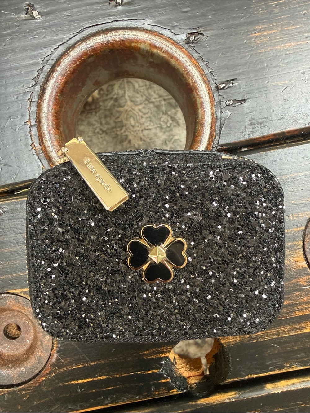 kate spade black glitter cosmetic pouch with gold-tone spade-flower charm